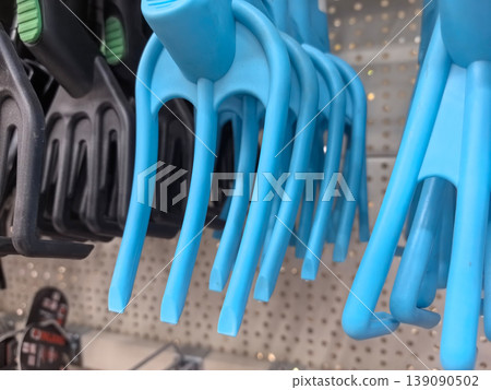 Colorful blue clips hanging on display in a local hardware store Colorful blue clips hanging on display in a local hardware store 139090502