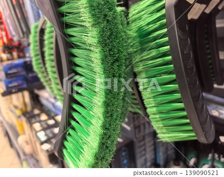 Colorful brushes hanging in store, ready for cleaning tasks and creativity Colorful brushes hanging in store, ready for cleaning tasks and creativity 139090521