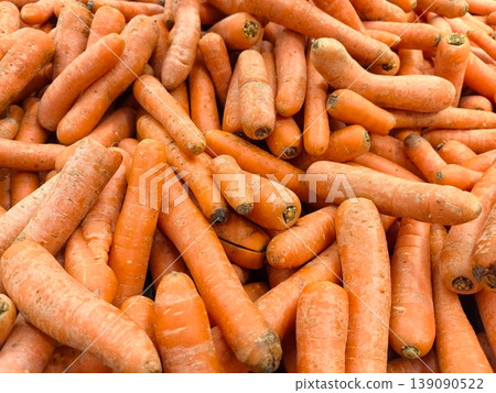 Vibrant carrots piled high at the local farmers market on a sunny day 139090522
