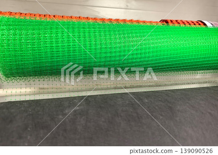 Bright green mesh rolls stacked for construction and safety projects 139090526