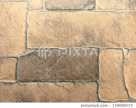 Textured stone wall adds warmth and natural tones to any space 139090553