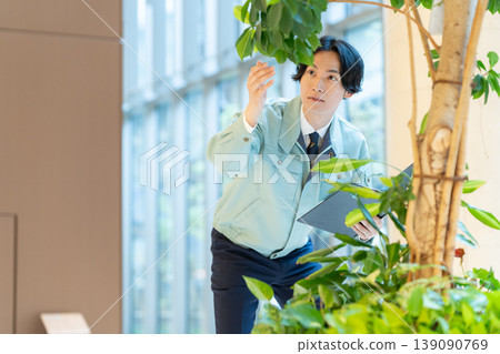 Workers inspecting rented plants in an office building. Photo courtesy of Denpa Gakuen Educational Foundation, Tokyo Electronics College. Workers inspecting rented plants in an office building. Photo courtesy of Denpa Gakuen Educational Foundation, Tokyo Electronics College. 139090769