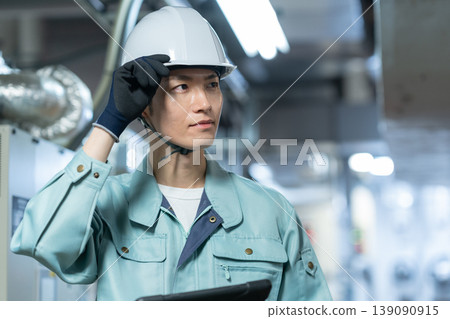 A male engineer performing building maintenance. Filming assistance provided by: Denpa Gakuen Educational Foundation, Tokyo Electronics College. 139090915