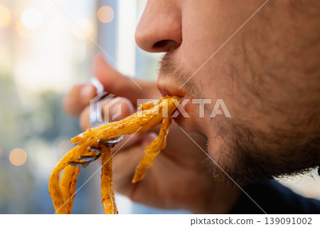 man eats fat pasta, sucks it with his mouth. concept of obesity, diabetes, gluttony, diabetes, overeating, close-up of his chewing mouth 139091002