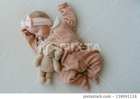 Baby girl lying on soft background with a plush toy. Minimal composition and gentle tones create a warm parenting scene. 4 Month Baby girl lying on soft background with a plush toy. Minimal composition and gentle tones create a warm parenting scene. 4 Month 139091138
