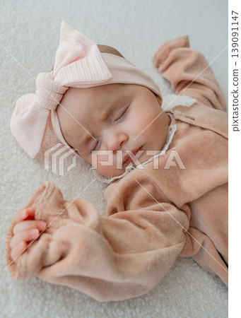 Infant resting in a minimal home setting. Soft textures and pastel tones evoke comfort, safety, and early childhood care. Infant resting in a minimal home setting. Soft textures and pastel tones evoke comfort, safety, and early childhood care. 139091147