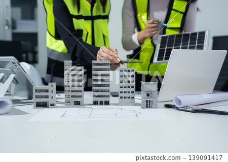 Engineer teams hand working and laptop with on on architectural project at construction site at desk in office. Engineer teams hand working and laptop with on on architectural project at construction site at desk in office. 139091417
