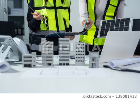 Concept architects or engineer holding pen pointing equipment architects on the desk with a blueprint in the office. Concept architects or engineer holding pen pointing equipment architects on the desk with a blueprint in the office. 139091418