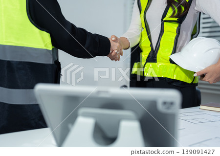construction worker and contractor. Client shaking hands with team builder in renovation site in the morning. construction worker and contractor. Client shaking hands with team builder in renovation site in the morning. 139091427