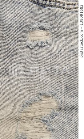 Close-up of a torn holes in jeans Close-up of a torn holes in jeans 139091682