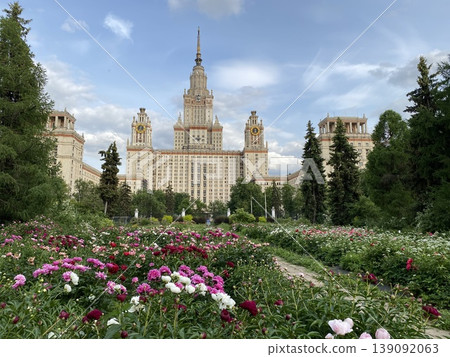 Main building of moscow state university surrounded by colorful flower garden on a clear day Main building of moscow state university surrounded by colorful flower garden on a clear day 139092063