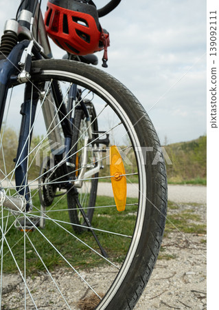 Orange spoke reflector on a bicycle wheel close up. 139092111
