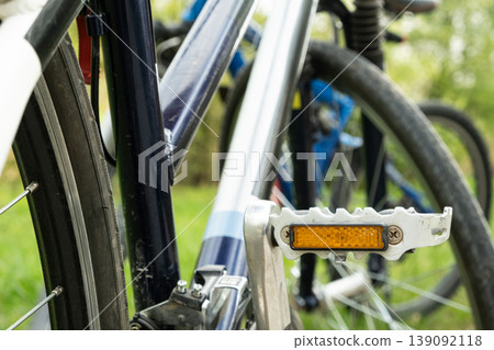Close-up of an orange safety reflector on a bicycle pedal. Close-up of an orange safety reflector on a bicycle pedal. 139092118