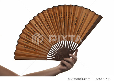 Elegant Hand Holding Decorative Fan on White. Woman Hand with Folding Fan Isolated Studio Shot. 139092340