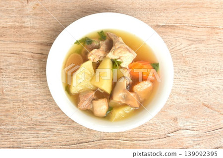 boiled pineapple with pork bone and carrot couple pickled radish topping black mushroom soup on bowl boiled pineapple with pork bone and carrot couple pickled radish topping black mushroom soup on bowl 139092395