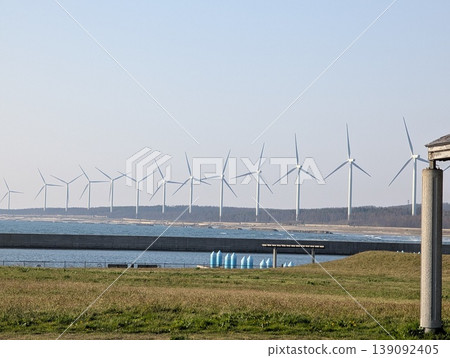 Wind turbines lined up along the coast: Renewable energy and a sustainable society Wind turbines lined up along the coast: Renewable energy and a sustainable society 139092405