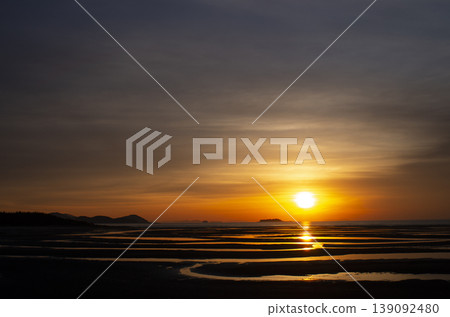 Geometric patterns in the water created by tidal flats Geometric patterns in the water created by tidal flats 139092480