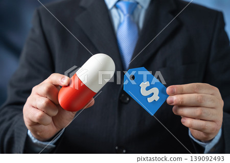 Businessman holds a medical capsule in his hand and dollar price tag. Cost of medicine, healthcare expenses, pharmaceutical pricing, drug affordability, and financial decisions in the medical industry 139092493
