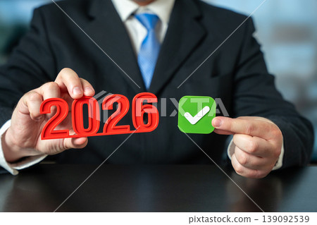 2026 year with green check mark in hands. 2026 year with green check mark in hands. 139092539