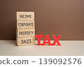 Wooden blocks with the words Tax, income, corporate, property, sales. Different tax categories, taxation system, financial obligations, and revenue collection. 139092576