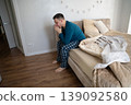 35 year old caucasian man sits on his bed in his pajamas in the bedroom in the morning. Waking up after a night's sleep and routine, lifestyle concept 139092580
