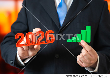 2026 year business growth. businessman holding rising graph showing success, revenue increase 139092582