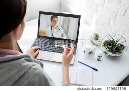 A woman with a high fever got the flu, an online consultation with her physician therapist. Medical technology, video chat with a doctor 139093196