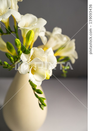 White floral spring, easter background. Freesia white flowers in vase White floral spring, easter background. Freesia white flowers in vase 139093436