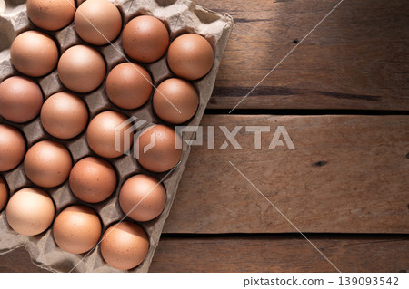Fresh Brown Eggs in Carton on Wooden Table Fresh Brown Eggs in Carton on Wooden Table 139093542