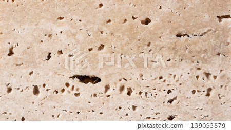 A background material with a beige travertine/natural stone texture. Features a porous stone texture. A background material with a beige travertine/natural stone texture. Features a porous stone texture. 139093879