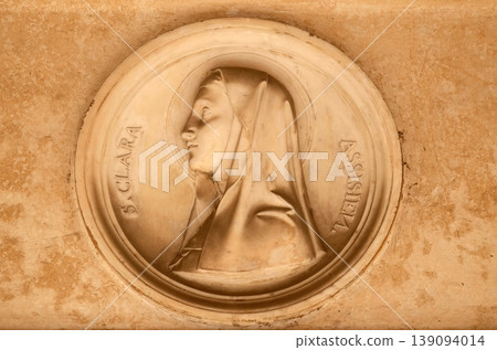 Saint Clare of Assisi, bass relief in portico of church dei Santi XII Apostoli in Rome, Italy Saint Clare of Assisi, bass relief in portico of church dei Santi XII Apostoli in Rome, Italy 139094014