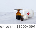 Iodine bottle, bandage, and first aid kit on table. Medical supplies for wound care, hygiene, and emergency treatment concept. 139094096