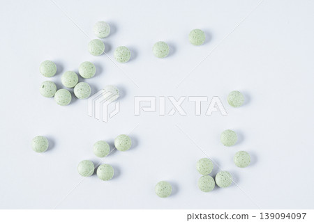 Kelp iodine tablets on white background. Natural supplement for thyroid support, iodine source, and healthy metabolism concept. Kelp iodine tablets on white background. Natural supplement for thyroid support, iodine source, and healthy metabolism concept. 139094097