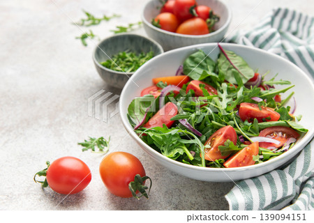 Fresh green salad with tomatoes and red onion Fresh green salad with tomatoes and red onion 139094151
