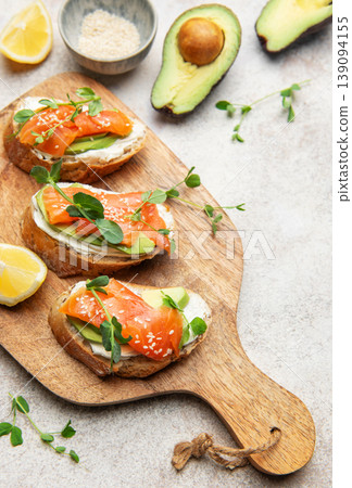 Salmon avocado bruschetta with cream cheese and greens Salmon avocado bruschetta with cream cheese and greens 139094155