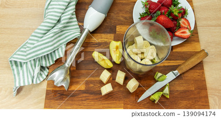 Preparing fruit smoothie with banana strawberries and kiwi Preparing fruit smoothie with banana strawberries and kiwi 139094174