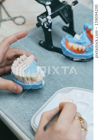 Creating custom ceramic dentures in a modern dental laboratory 139094200