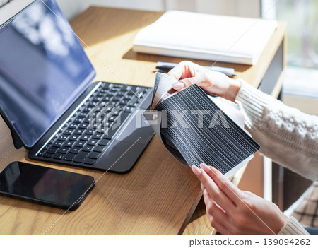 Designer choosing material swatches at home office workspace 139094262