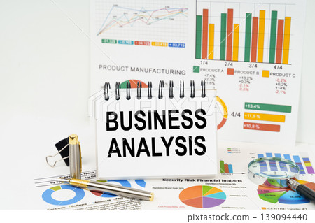 On the table are reports with graphs and a notepad with the inscription - BUSINESS ANALYSIS On the table are reports with graphs and a notepad with the inscription - BUSINESS ANALYSIS 139094440
