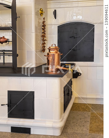 Vintage copper pot rests atop stone kitchen counter Vintage copper pot rests atop stone kitchen counter 139094611