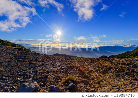 A sea of clouds and sunrise viewed from Jōnen-Norikoshi Pass in the Northern Alps: A hopeful morning mountain landscape. A sea of clouds and sunrise viewed from Jōnen-Norikoshi Pass in the Northern Alps: A hopeful morning mountain landscape. 139094716