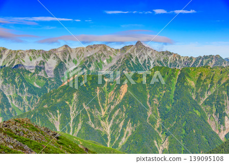 The Northern Alps: Cap clouds remaining over Mt. Yarigatake and the Hotaka mountain range; a spectacular view from just below the summit of Mt. Jonen. The Northern Alps: Cap clouds remaining over Mt. Yarigatake and the Hotaka mountain range; a spectacular view from just below the summit of Mt. Jonen. 139095108