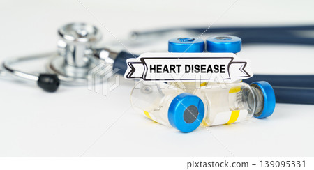 On the table there is a stethoscope, injections and a sign with the inscription - Heart disease 139095331
