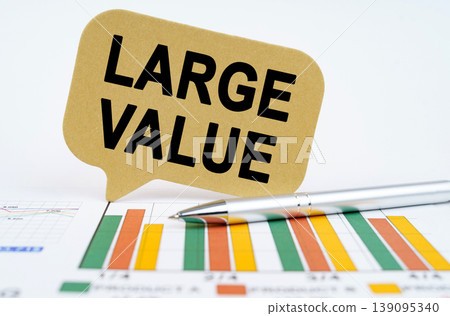 On the financial charts lies a pen and a sign with the inscription - Large Value On the financial charts lies a pen and a sign with the inscription - Large Value 139095340