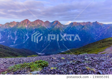 The morning glow on the Yari-Hotaka mountain range in the Northern Alps: Mt. Yari and Mt. Hotaka bathed in red by the rising sun. The morning glow on the Yari-Hotaka mountain range in the Northern Alps: Mt. Yari and Mt. Hotaka bathed in red by the rising sun. 139095391