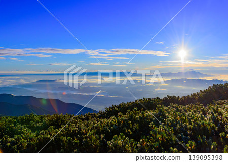 The sunrise from Mt. Chogatake in the Northern Alps: A spectacular view of the rising sun and sea of clouds from above Mt. Asama. The sunrise from Mt. Chogatake in the Northern Alps: A spectacular view of the rising sun and sea of clouds from above Mt. Asama. 139095398
