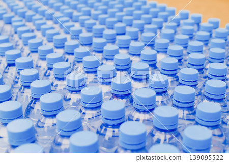 Rows of blue plastic water bottles closeup abstract pattern at sport event outdoor Rows of blue plastic water bottles closeup abstract pattern at sport event outdoor 139095522