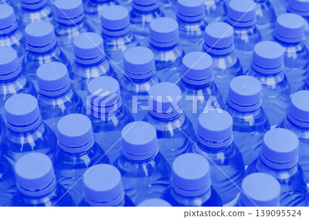 Rows of blue plastic water bottles packed together closeup abstract pattern at sport event outdoor Rows of blue plastic water bottles packed together closeup abstract pattern at sport event outdoor 139095524