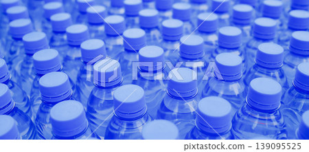 Rows of blue plastic water bottles packed together closeup abstract pattern at sport event banner background Rows of blue plastic water bottles packed together closeup abstract pattern at sport event banner background 139095525