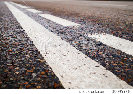 road markings on dark asphalt surface closeup road markings on dark asphalt surface closeup 139095526